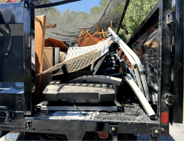 Professional junk removal team loading furniture